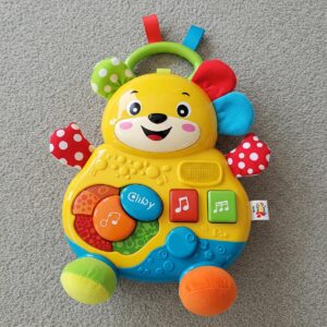 A bright musical toy designed for infants aged 6-12 months, promoting sensory exploration and auditory development.