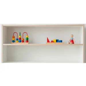A minimalist Montessori toy shelf featuring a simple, uncluttered arrangement of a few high-quality, open-ended toys to promote deeper engagement.