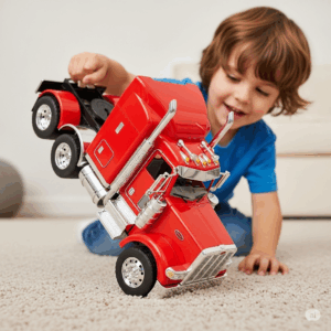 Child playing with a modern Peterbilt 579 toy truck on a carpeted floor, demonstrating its durability