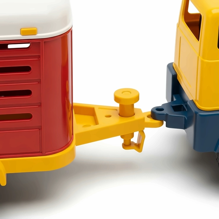 Detail shot of the durable hitch on a toy cattle trailer, showing its easy connection mechanism to a toy truck.
