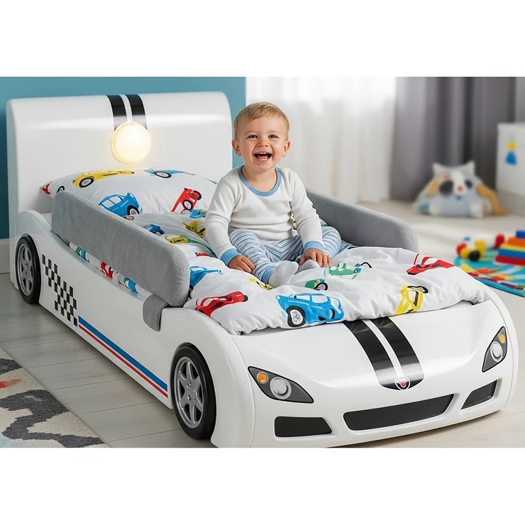 A sleek white racecar bed is shown with a toddler happily sitting on it, demonstrating its safety features and suitability for young children.