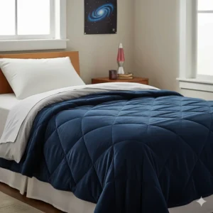 A dark blue weighted blanket draped over a twin bed in a teen's room, a popular calming sensory tool for managing anxiety and improving sleep.