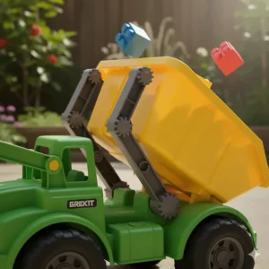 Close-up view of the movable rear dumpster bin mechanism on the plastic truck toy.