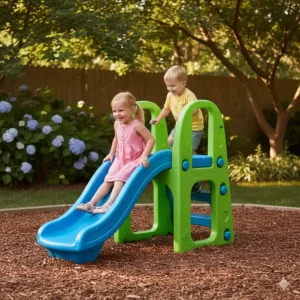 Durable green and blue plastic climber and slide combo set, a perfect outdoor toy for backyard fun for young children.