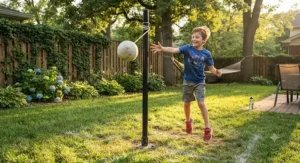 A boy hitting a tetherball during an energetic backyard game on a sunny afternoon.