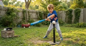 Boy practicing his swing with a plastic baseball bat and tee set