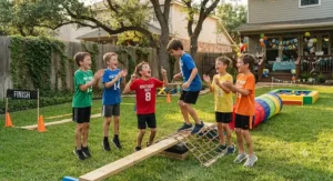 Group of energetic boys cheering during a backyard obstacle course birthday party game