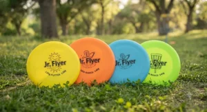 Close-up of a beginner disc golf set for kids showing colorful putters and mid-range discs.